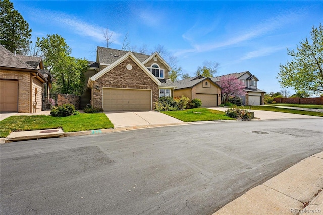 2252 S Yosemite Cir, Denver, CO 80231 - traditional-style home with an attached garage, a front yard, driveway, and brick siding