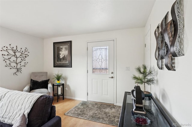 entryway featuring light wood-type flooring and baseboards