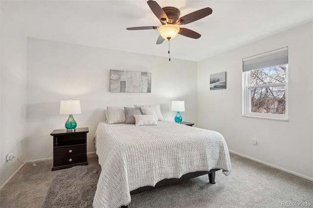 carpeted bedroom with ceiling fan and baseboards