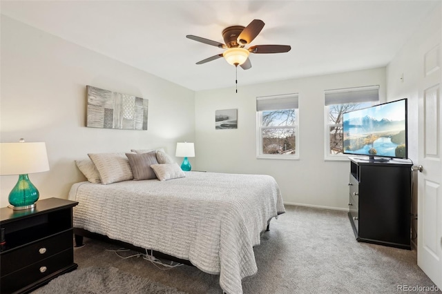 carpeted bedroom featuring ceiling fan and baseboards