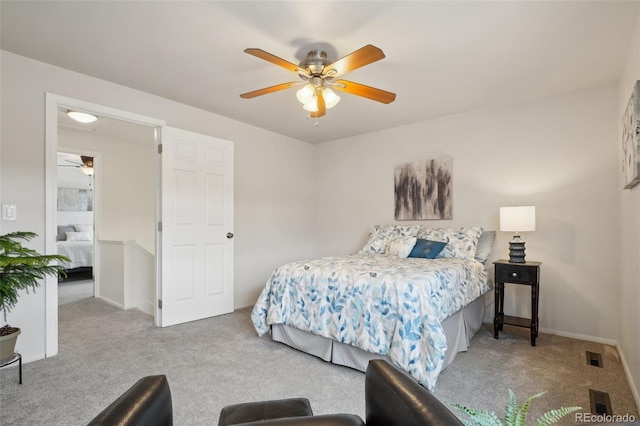 bedroom with baseboards, carpet flooring, visible vents, and a ceiling fan