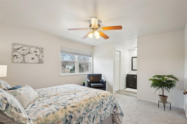 bedroom with carpet floors, a ceiling fan, baseboards, and connected bathroom