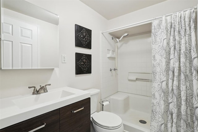 bathroom featuring toilet, vanity, and a shower with shower curtain