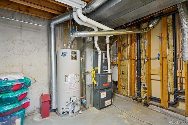 utility room with heating unit and water heater