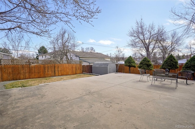 exterior space with a fenced backyard, an outbuilding, and a shed