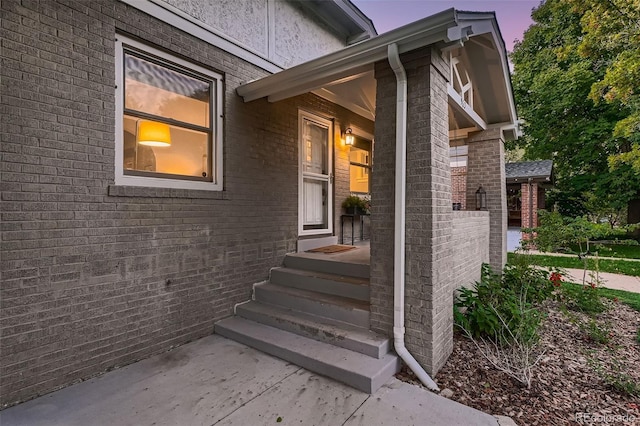 view of exterior entry at dusk