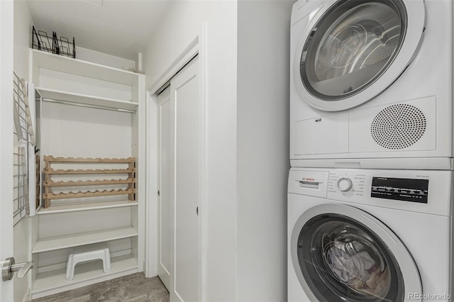 laundry room featuring laundry area and stacked washer and clothes dryer