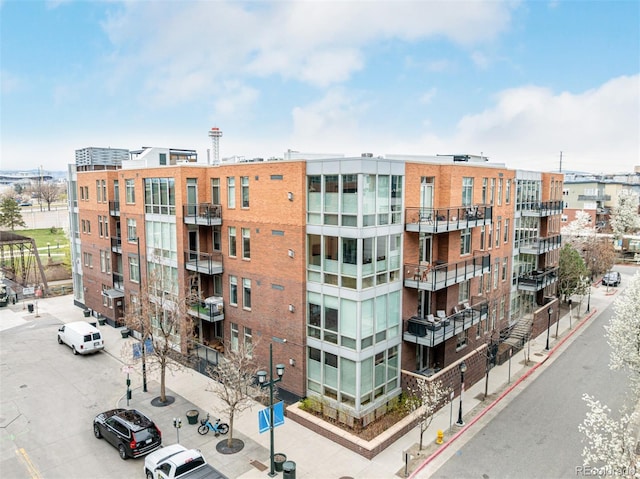 view of building exterior featuring uncovered parking