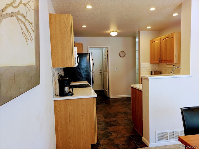 kitchen with white microwave, recessed lighting, visible vents, light countertops, and decorative backsplash