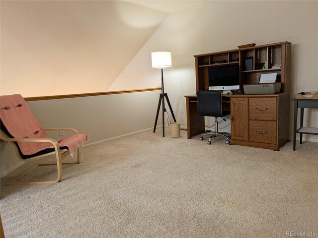 unfurnished office with light carpet, vaulted ceiling, and baseboards