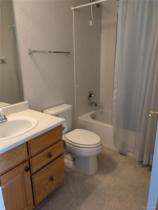 full bathroom with a textured wall, vanity, toilet, and shower / bathtub combination with curtain