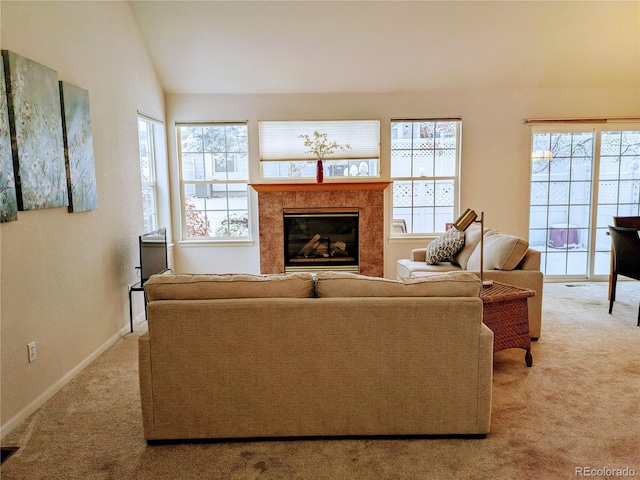 living area with vaulted ceiling, light colored carpet, a fireplace, and baseboards