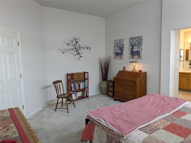 bedroom featuring carpet floors, baseboards, and connected bathroom