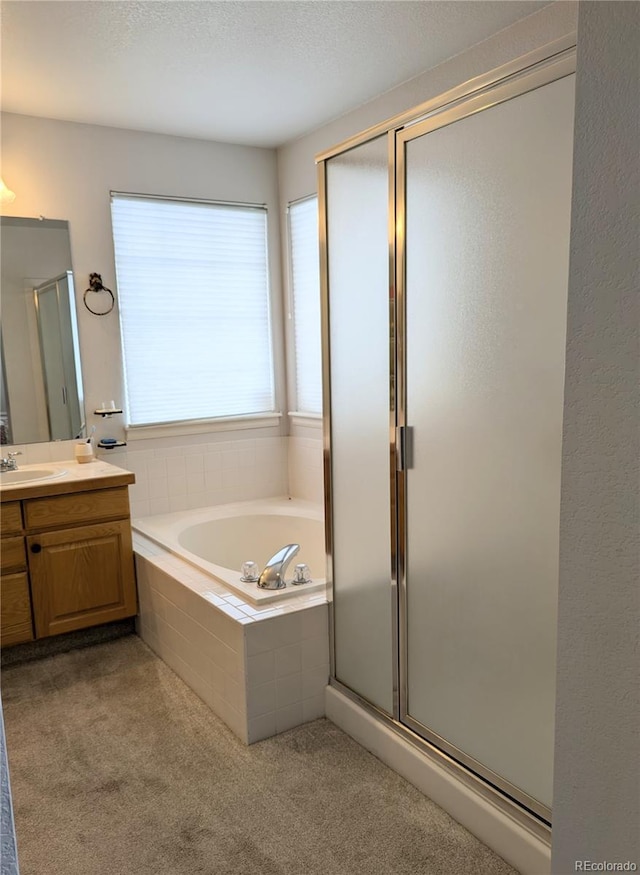 bathroom with a garden tub, carpet floors, a shower stall, and vanity