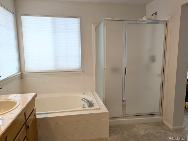 full bath featuring a garden tub, a shower stall, and vanity