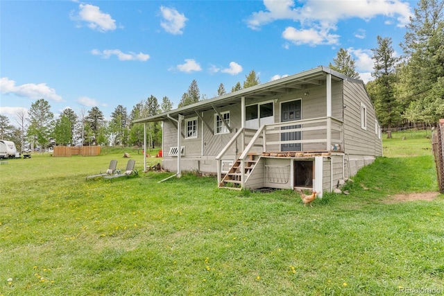 rear view of property featuring a yard