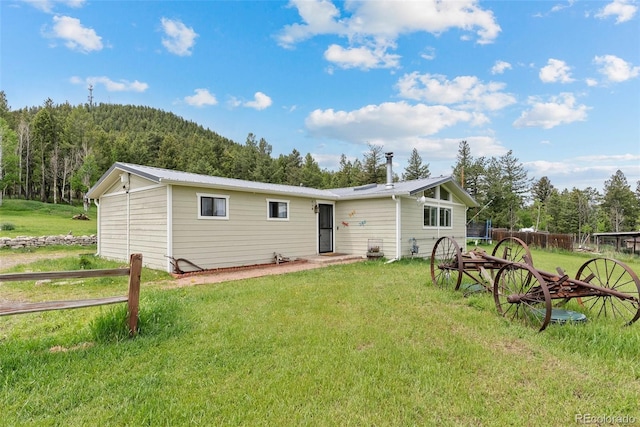 rear view of property with a lawn