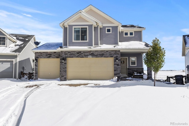 craftsman-style house featuring a garage and stone siding