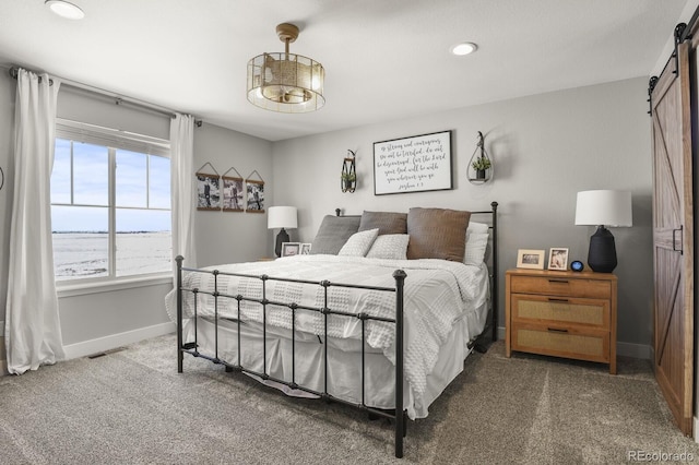 carpeted bedroom with a barn door, recessed lighting, visible vents, and baseboards