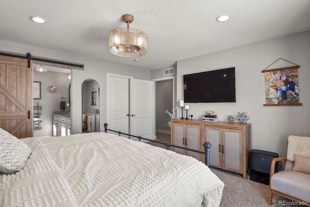 carpeted bedroom with recessed lighting, visible vents, baseboards, and a barn door