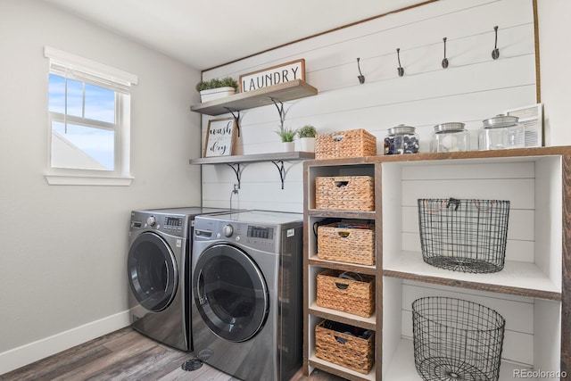 laundry room with baseboards, laundry area, wood finished floors, and washer and dryer