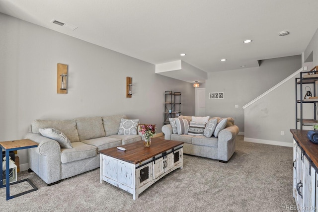 living area featuring light colored carpet, visible vents, baseboards, and recessed lighting