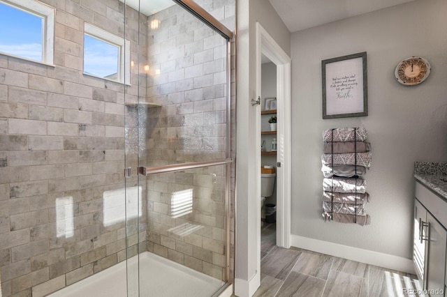 6654 Backcountry Loop, Colorado Springs, CO 80927 - full bathroom featuring baseboards, a stall shower, toilet, and vanity