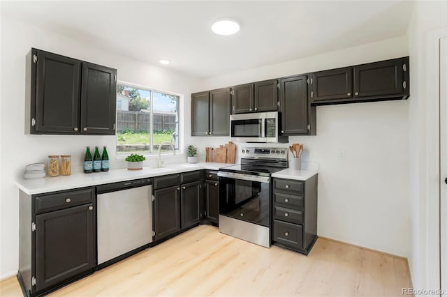 16322 E Idaho Pl, Aurora, CO 80017 - kitchen with appliances with stainless steel finishes, light wood-style flooring, and light countertops