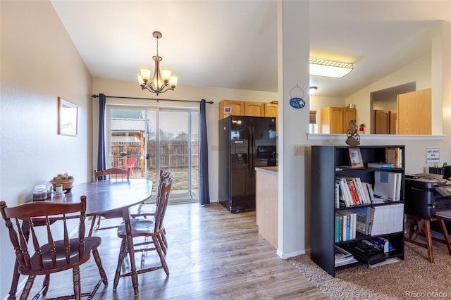 132 Windwalker Rd, Buena Vista, CO 81211 - dining area featuring an inviting chandelier, light wood-style floors, and vaulted ceiling