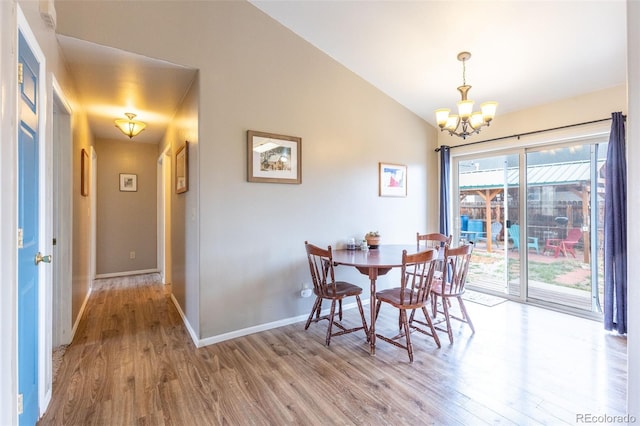 132 Windwalker Rd, Buena Vista, CO 81211 - dining room featuring baseboards, vaulted ceiling, wood finished floors, and a notable chandelier