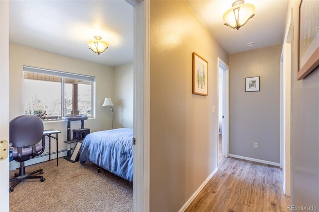 132 Windwalker Rd, Buena Vista, CO 81211 - bedroom featuring baseboards, baseboard heating, and wood finished floors