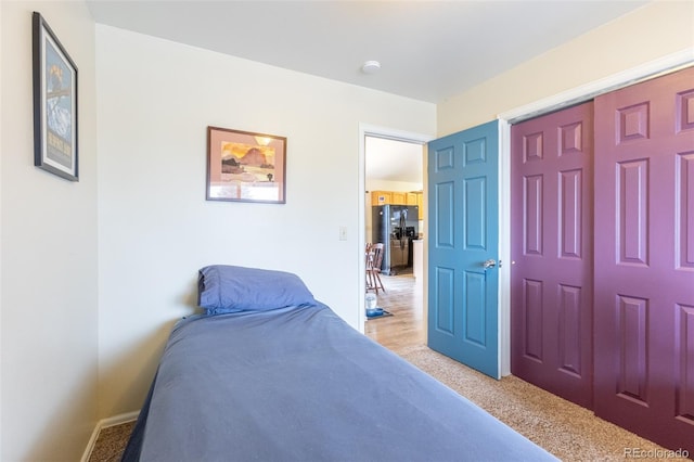 132 Windwalker Rd, Buena Vista, CO 81211 - bedroom with baseboards, black fridge, and light carpet