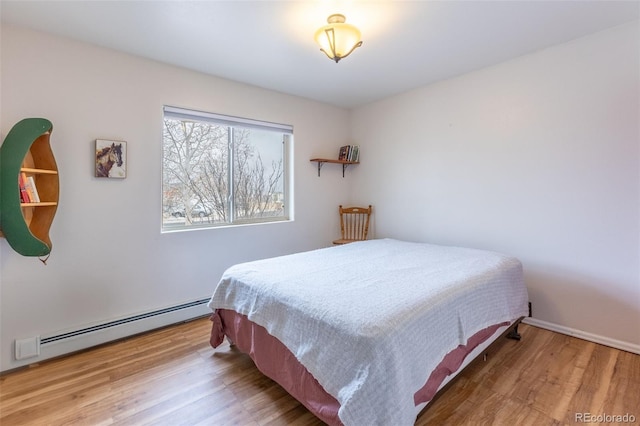 132 Windwalker Rd, Buena Vista, CO 81211 - bedroom with baseboard heating and wood finished floors