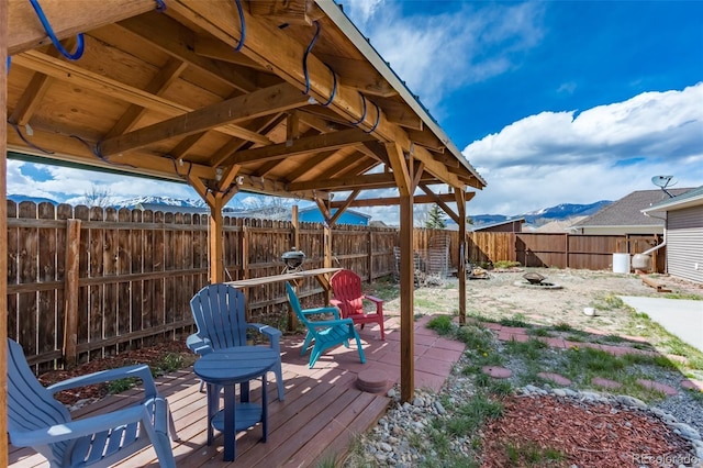 132 Windwalker Rd, Buena Vista, CO 81211 - wooden terrace with a fenced backyard, a mountain view, and a fire pit