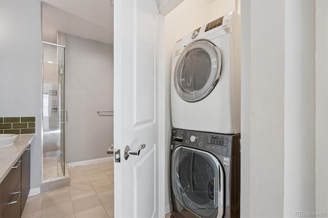 2335 Walnut St Unit 10, Denver, CO 80205 - laundry room featuring stacked washer / dryer and light tile patterned floors