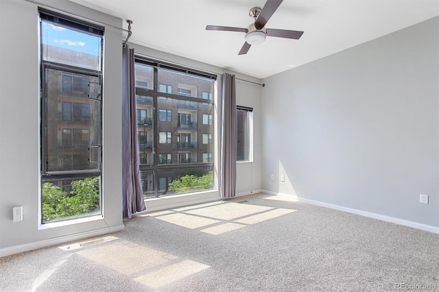 2335 Walnut St Unit 10, Denver, CO 80205 - spare room featuring carpet flooring, a ceiling fan, and healthy amount of natural light