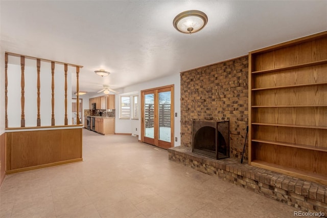 unfurnished living room with a fireplace and ceiling fan