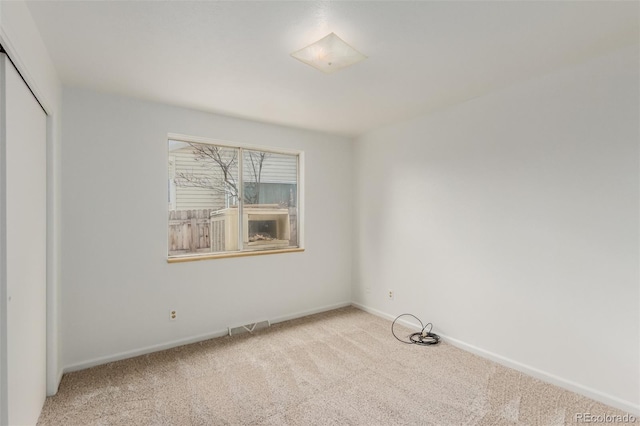 spare room with light colored carpet