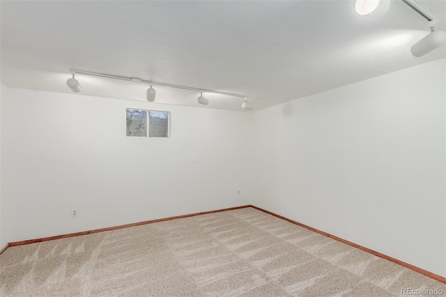 basement with carpet floors and track lighting