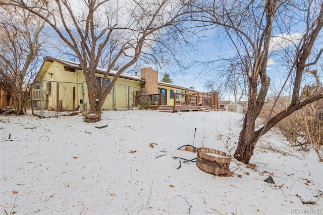 snowy yard with a deck