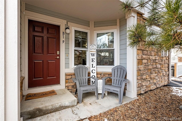 doorway to property featuring stone siding