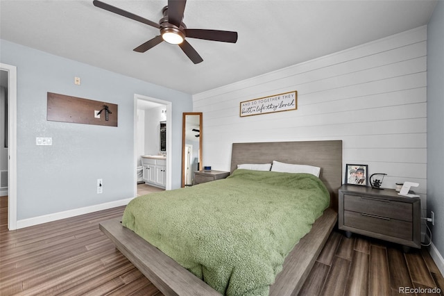 bedroom featuring ceiling fan, wood finished floors, connected bathroom, and baseboards