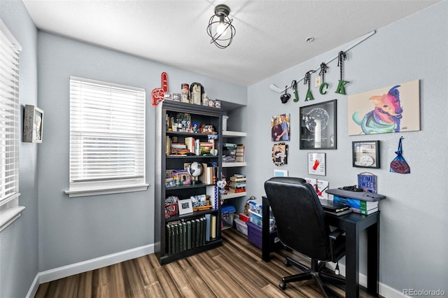 home office featuring baseboards and wood finished floors