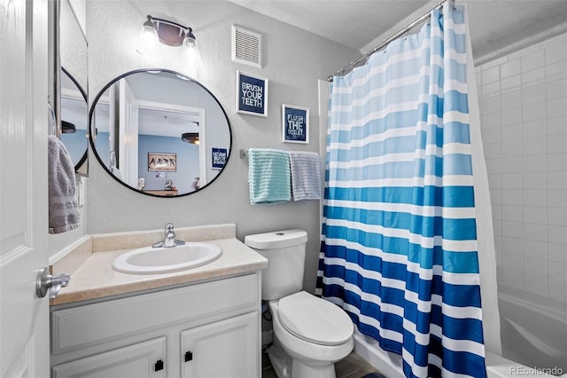 bathroom featuring visible vents, a textured wall, toilet, shower / bath combo with shower curtain, and vanity