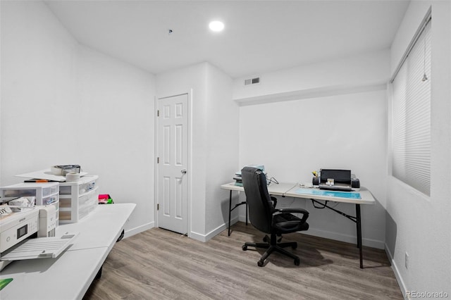 office with light wood-style floors, baseboards, visible vents, and recessed lighting