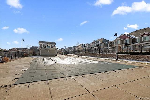 view of pool with fence and a residential view