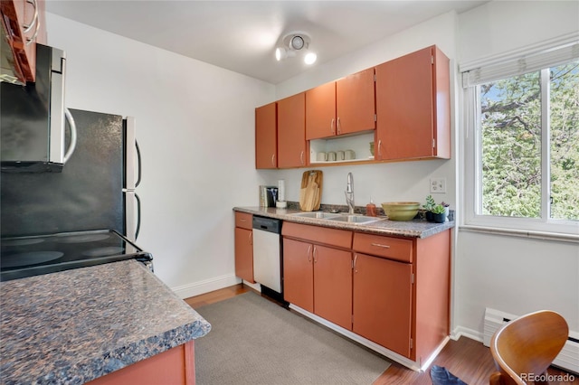 1201 Race St Unit 10, Denver, CO 80206 - kitchen with a sink, stainless steel appliances, baseboards, and light wood-style flooring
