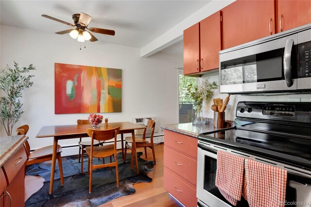 1201 Race St Unit 10, Denver, CO 80206 - kitchen featuring appliances with stainless steel finishes, a ceiling fan, light wood-style flooring, a wall unit AC, and light countertops