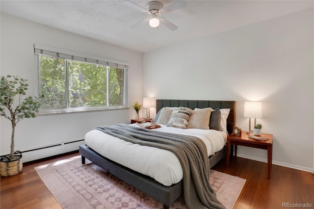 1201 Race St Unit 10, Denver, CO 80206 - bedroom with wood finished floors, a baseboard heating unit, baseboards, and a ceiling fan