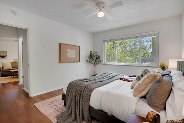 1201 Race St Unit 10, Denver, CO 80206 - bedroom with dark wood-style flooring, a textured ceiling, ceiling fan, and baseboards